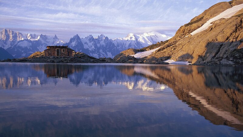 Mountain hut by a lake