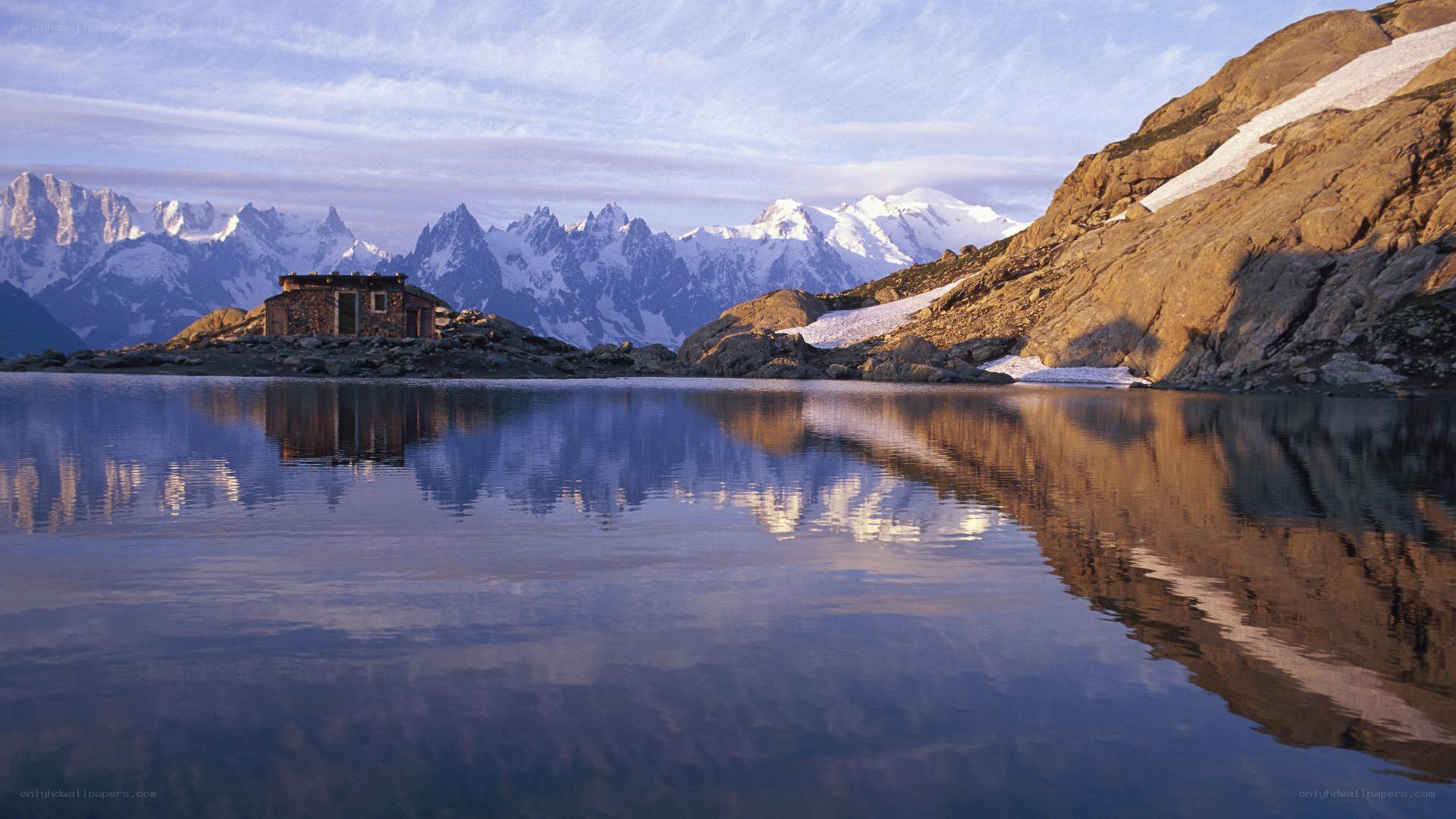 Mountain hut by a lake