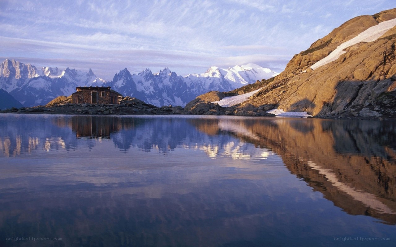 Mountain hut by a lake