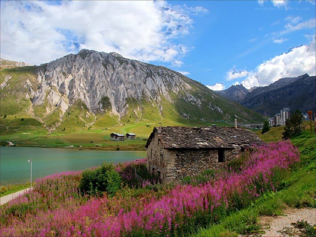 Mountain hut by a lake