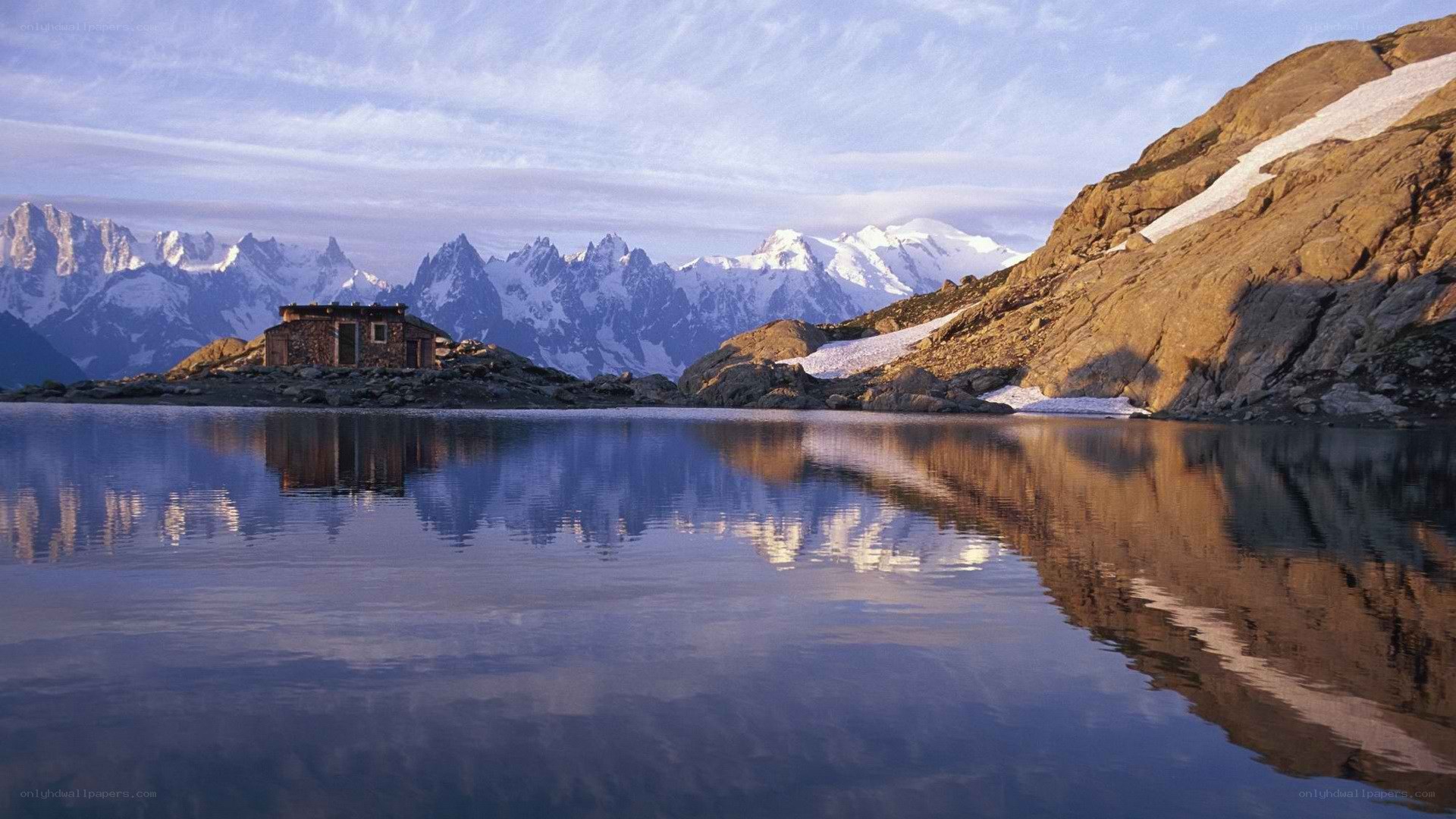 Mountain hut by a lake
