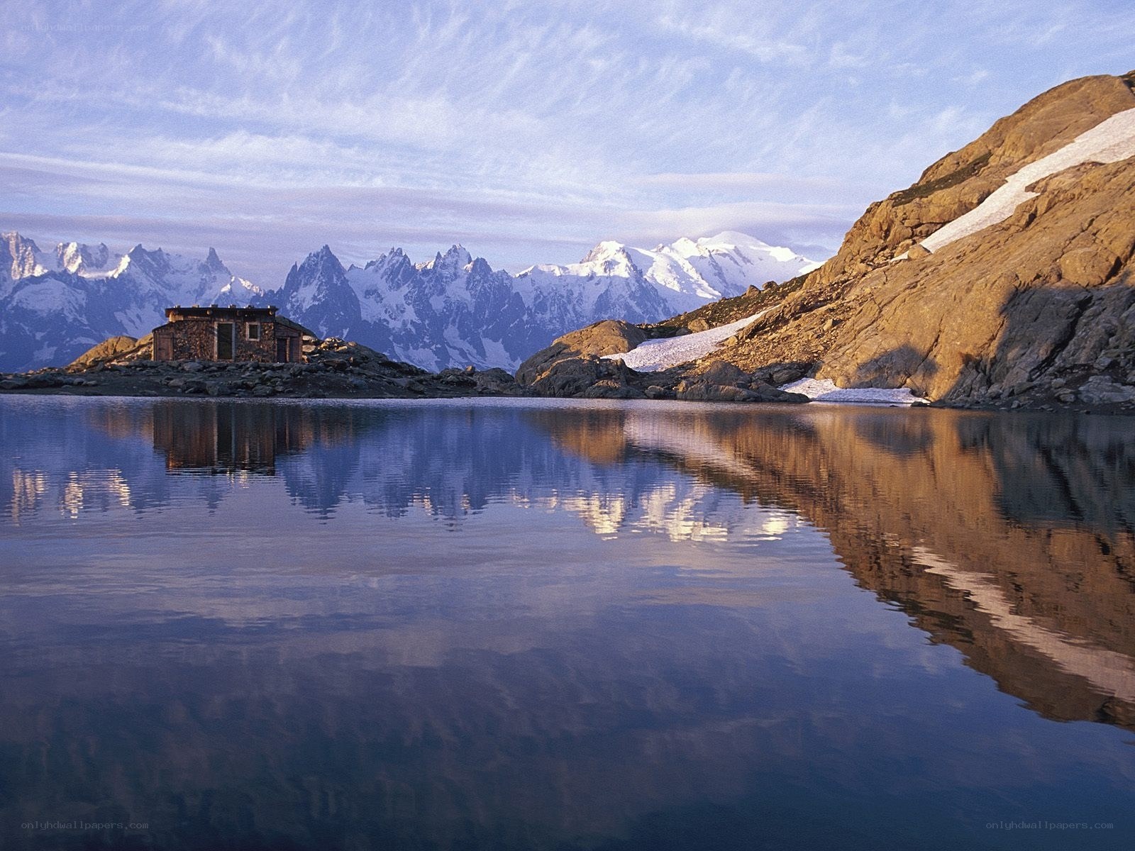 Mountain hut by alpine lake