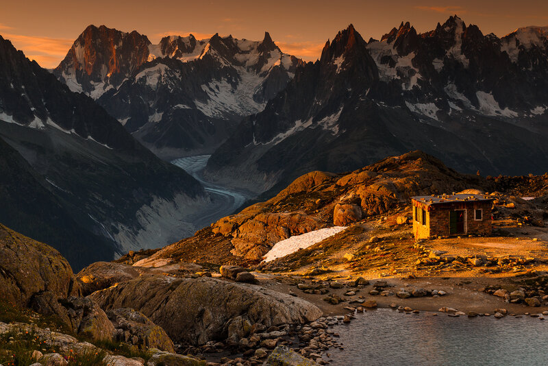 Mountain Hut in Alpine Valley — Orange, Dramatic