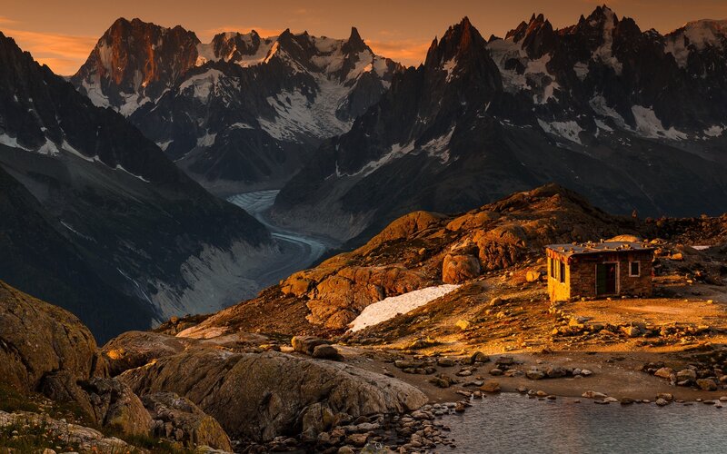 Mountain Hut in Alpine Valley — Orange