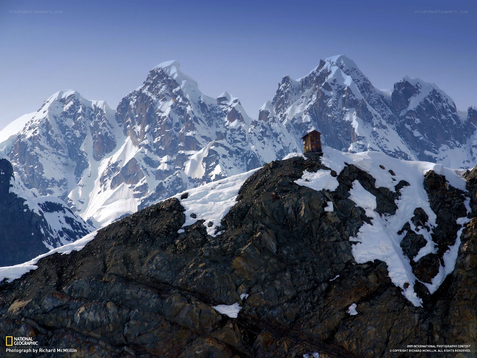 Mountain hut on a snowy peak
