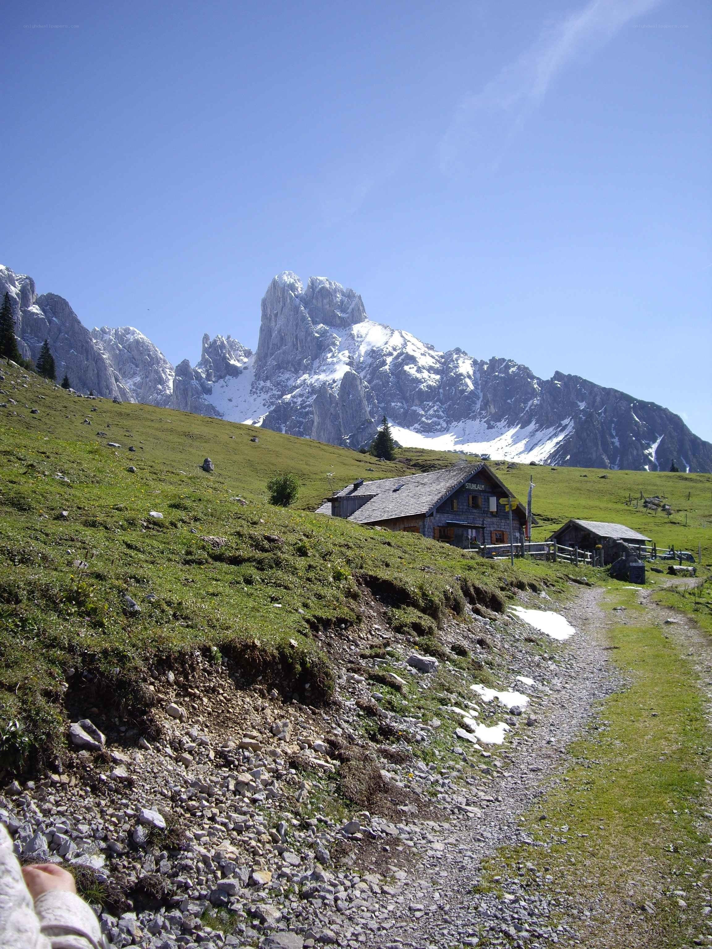 Mountain hut with alpine peaks