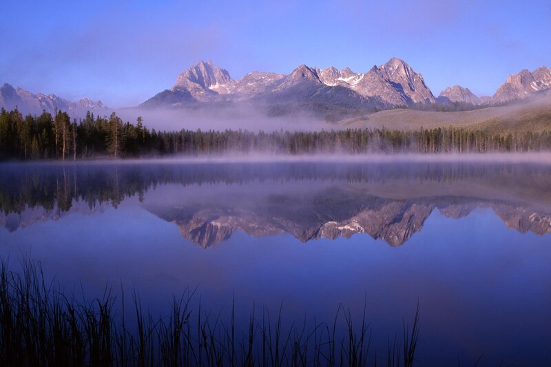 Mountain lake at dawn with fog