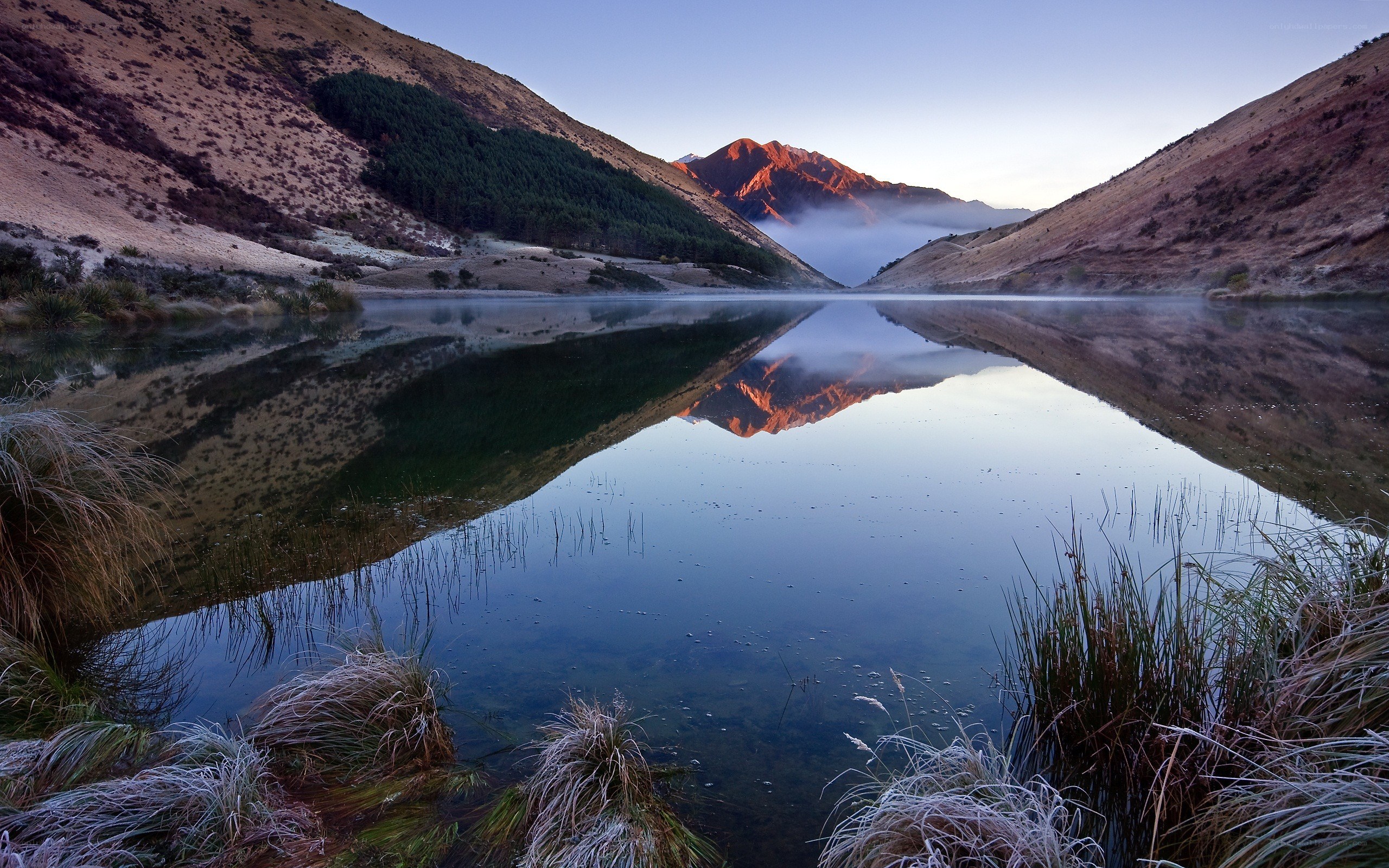 Mountain lake at dawn with reflection