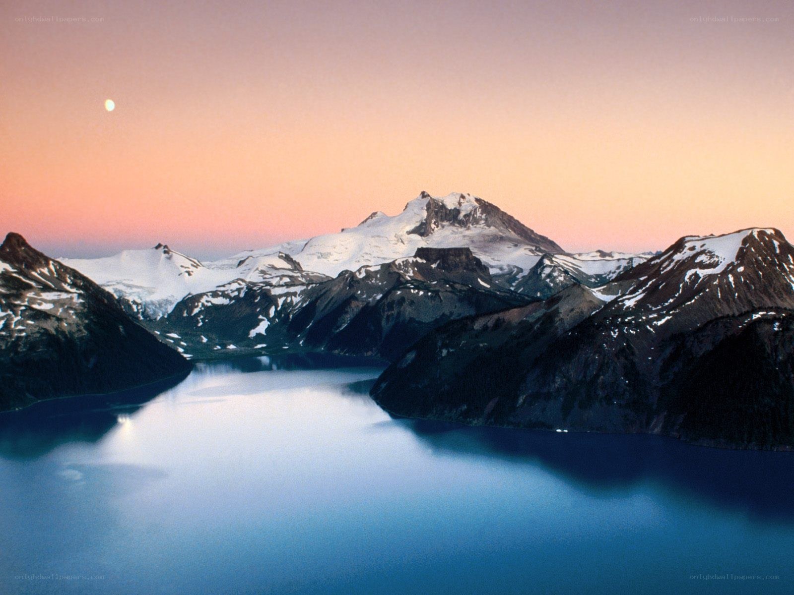 Mountain lake at dusk with moon