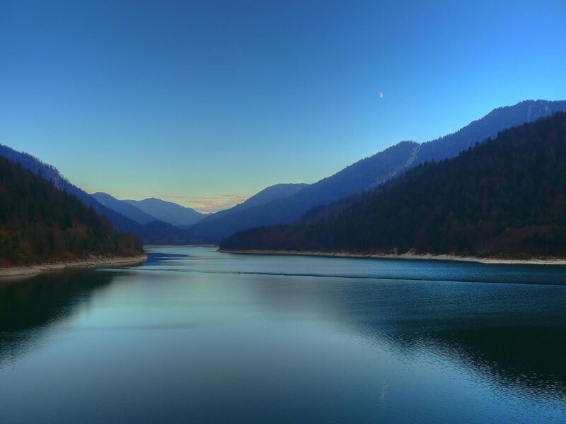 Mountain lake at dusk with moon