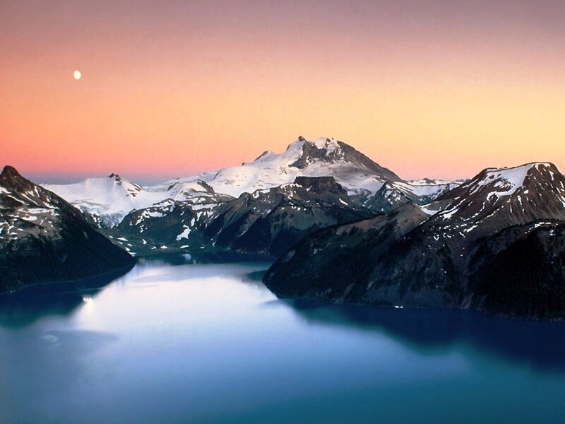 Mountain lake at dusk with moon