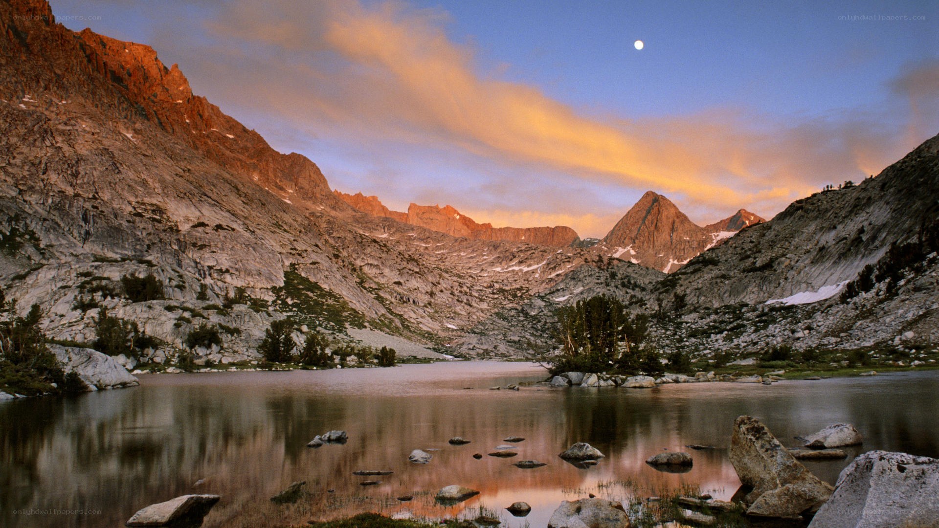 Mountain lake at dusk with moon