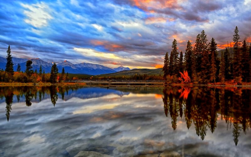 Mountain Lake at Sunset — Blue, Dramatic, Photograph, Mountains, Trees, Bridge