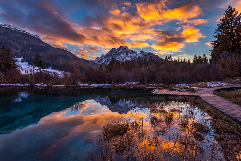 Mountain Lake at Sunset — Orange, Dramatic, Photograph, Mountains, Trees, Wooden Walkway