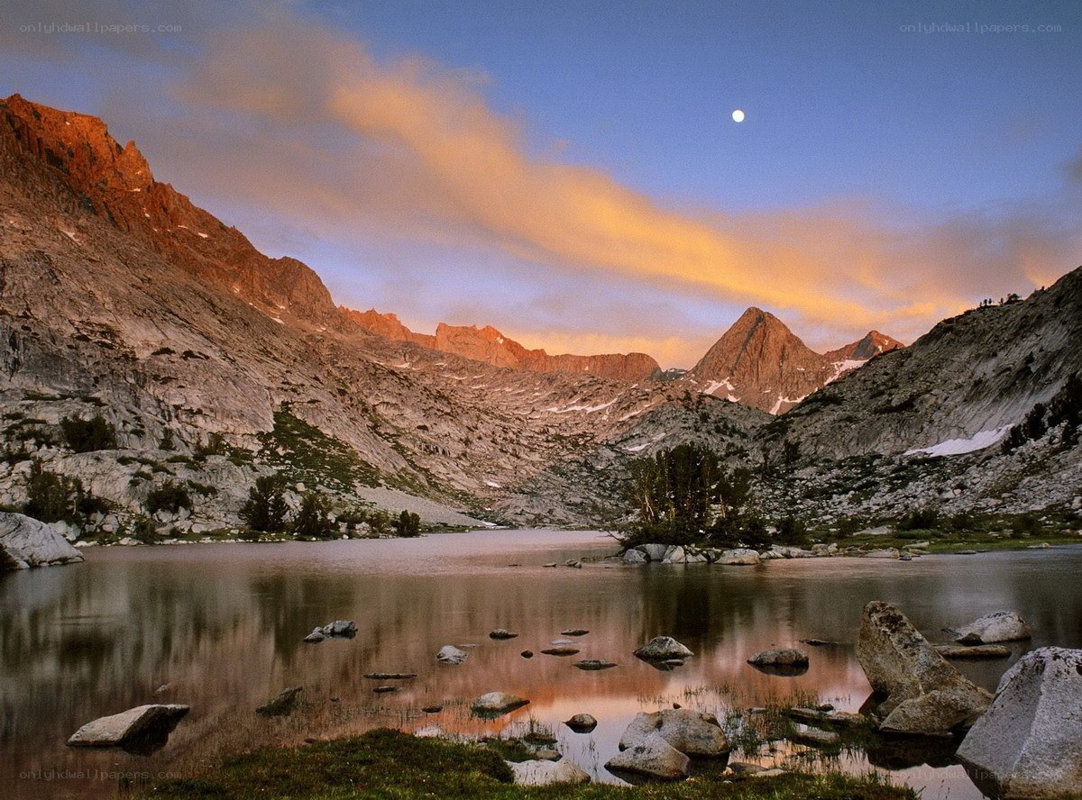 Mountain lake at sunset with moon