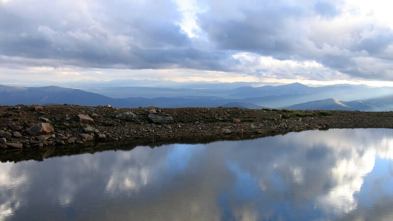 Mountain lake reflecting clouds