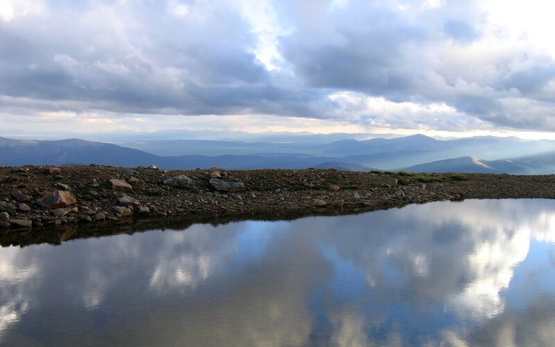 Mountain lake reflecting clouds