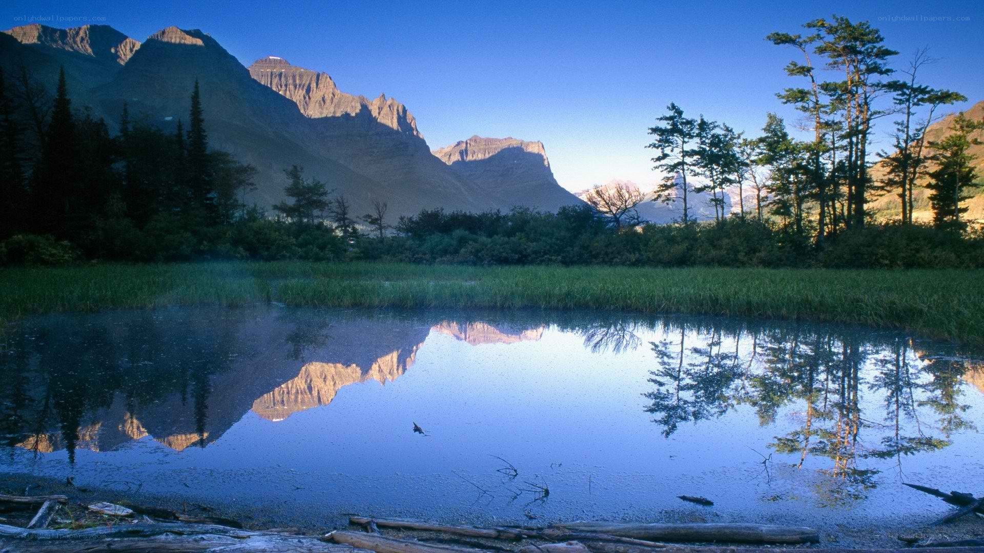 Mountain lake reflection at dawn
