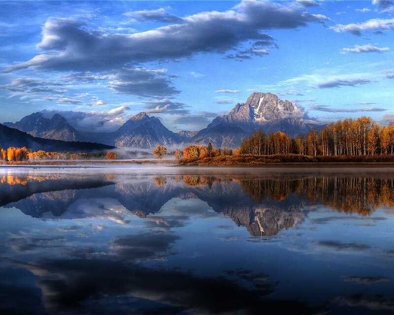 Mountain lake reflection at dawn