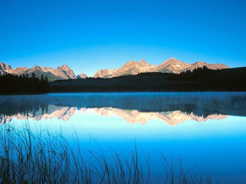 Mountain lake reflection at dawn