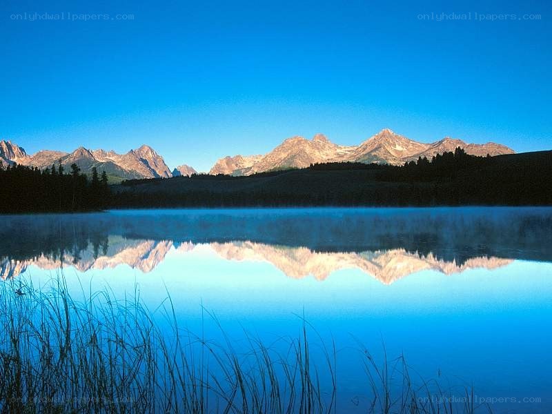 Mountain lake reflection at dawn