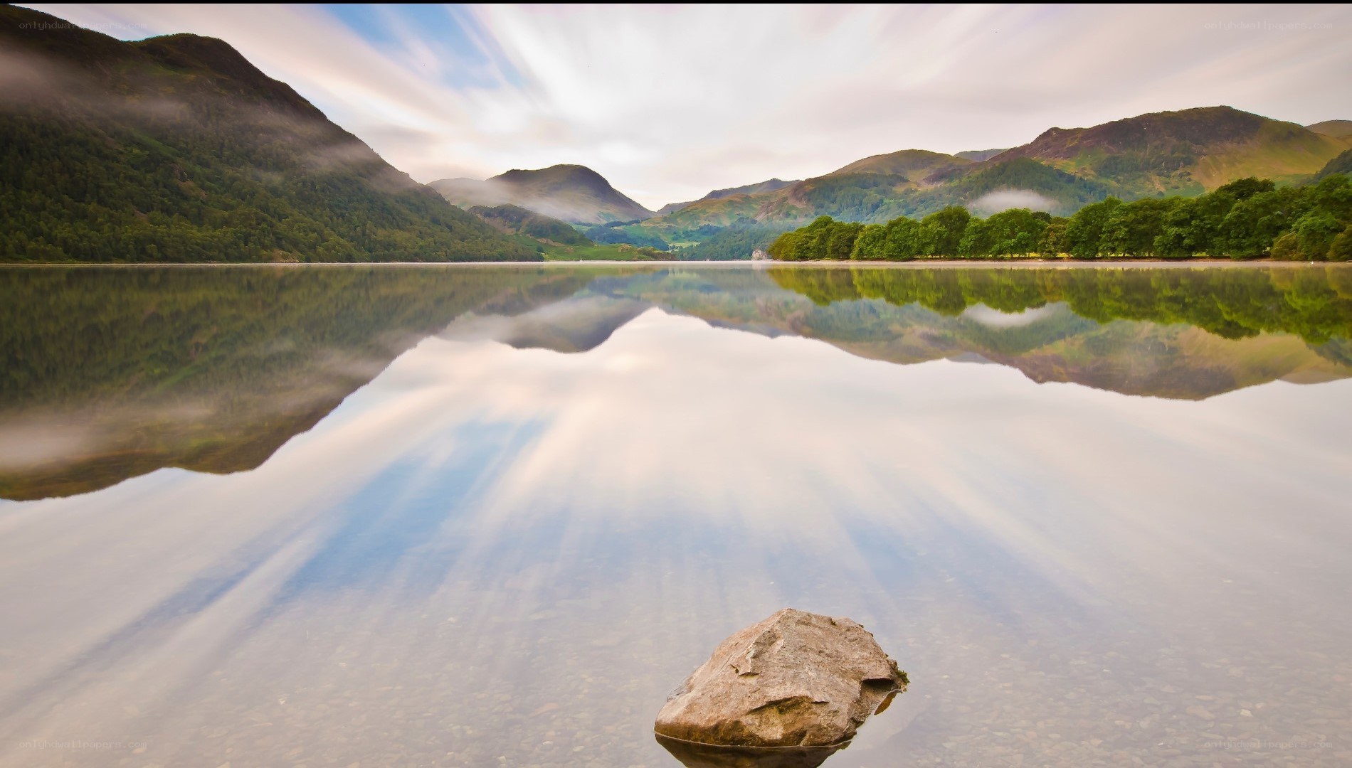 Mountain lake reflection at dawn