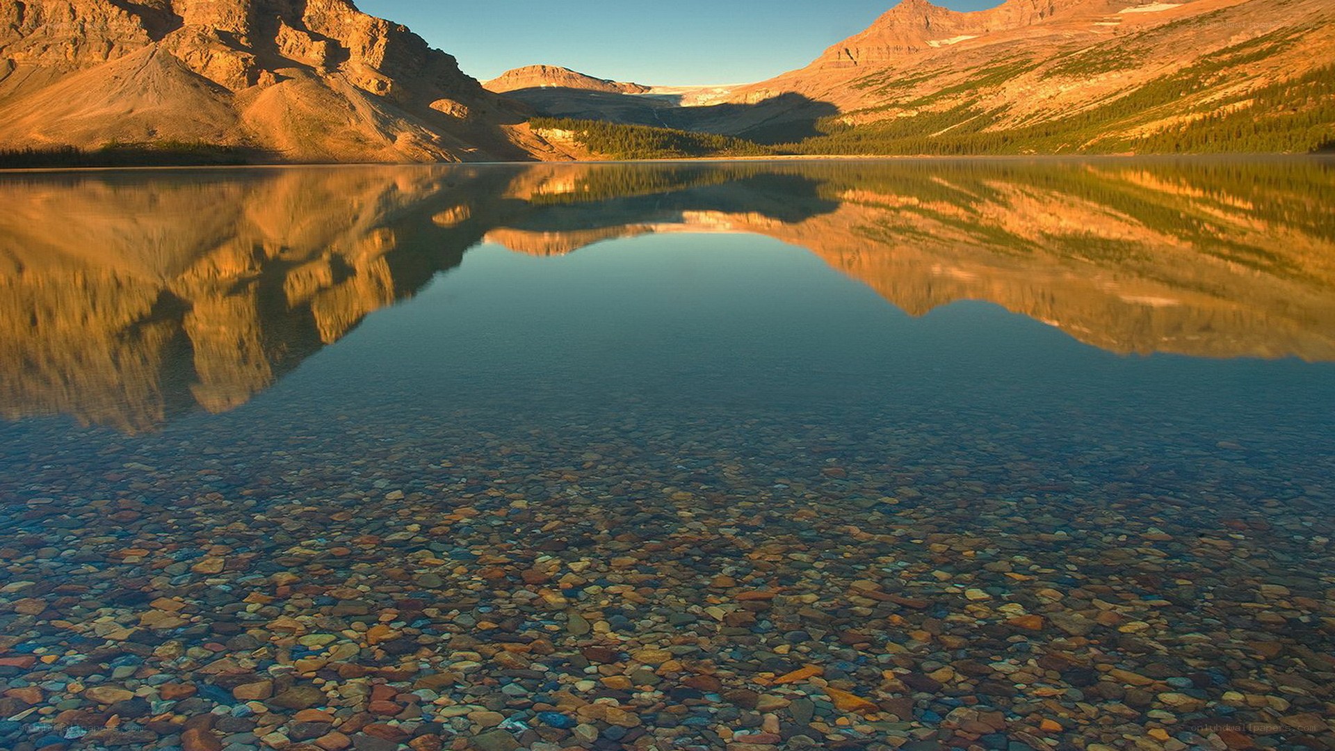 Mountain lake reflection at sunrise