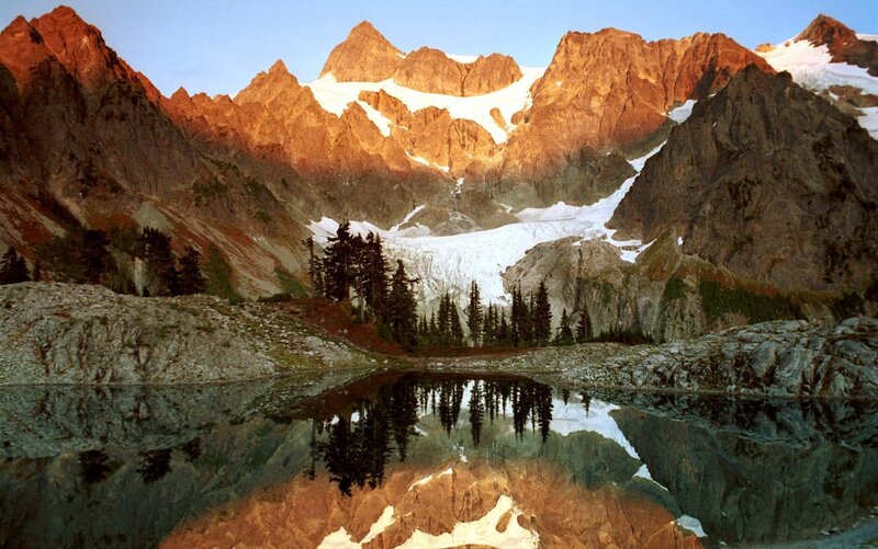 Mountain lake reflection at sunrise
