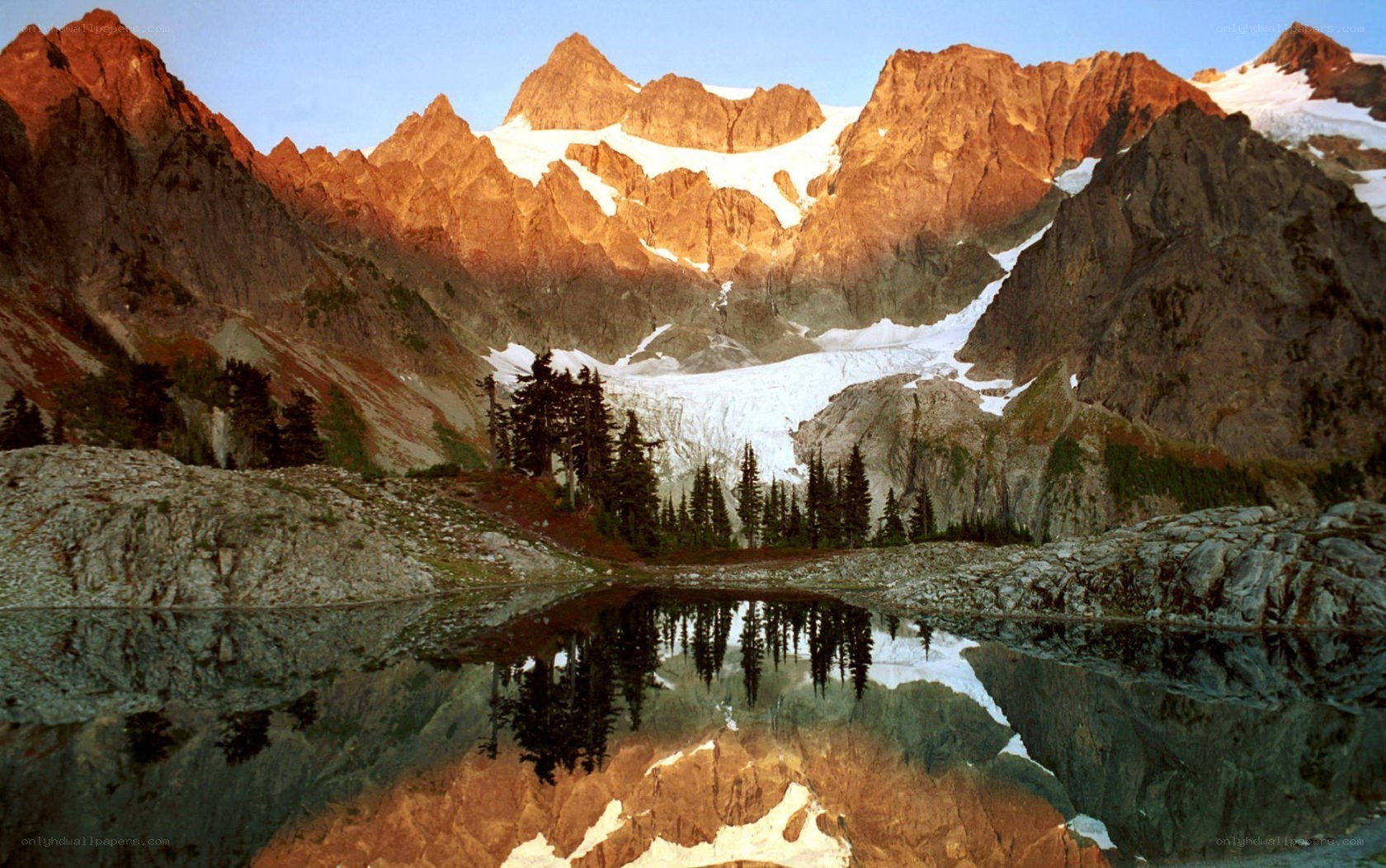Mountain lake reflection at sunrise