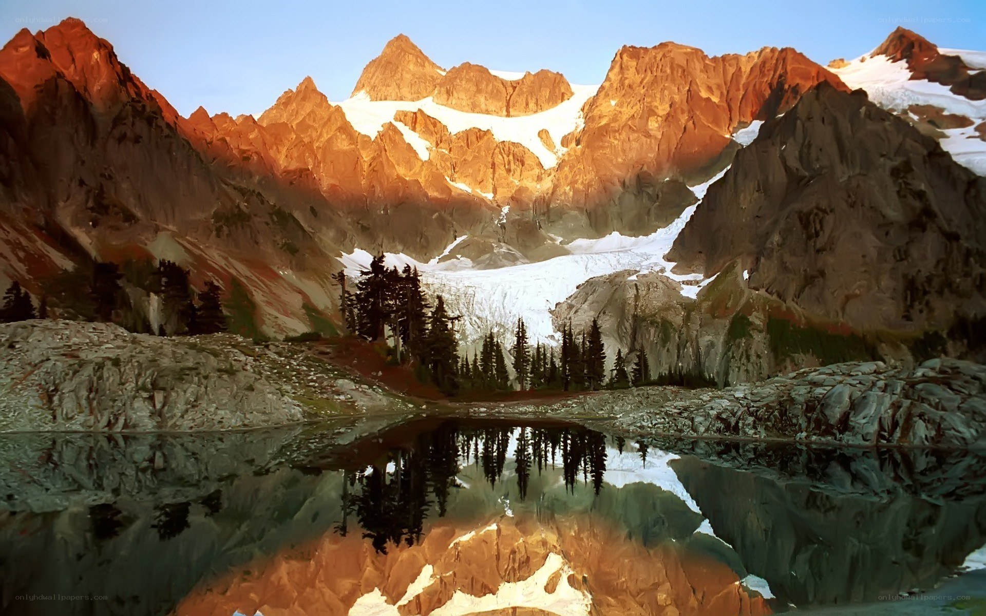 Mountain lake reflection at sunrise
