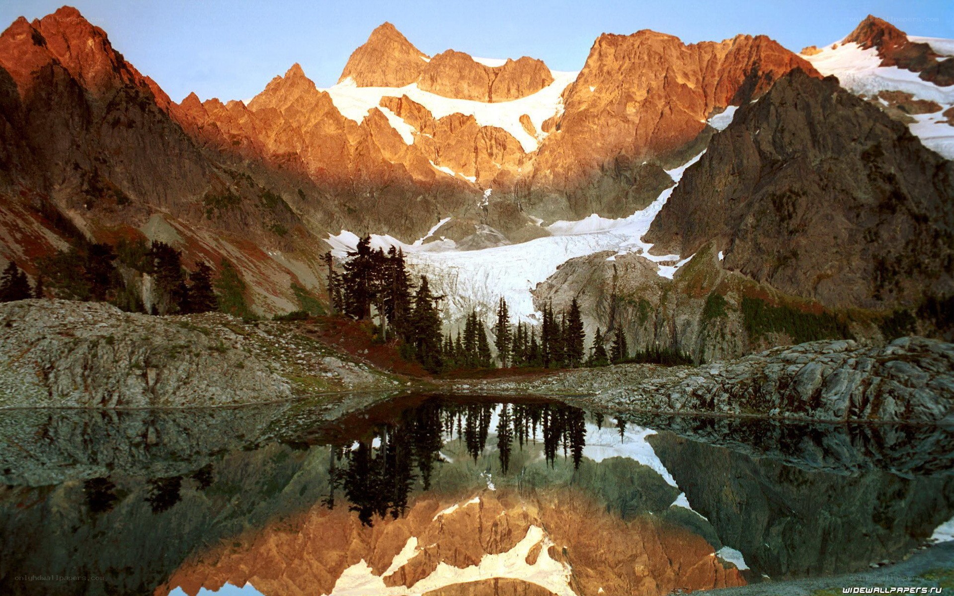 Mountain lake reflection at sunrise