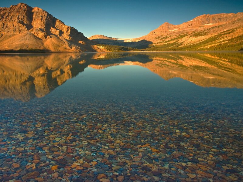 Mountain lake reflection at sunrise