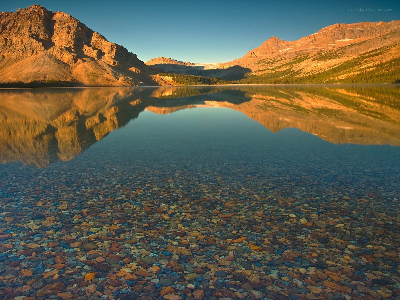 Mountain lake reflection at sunrise