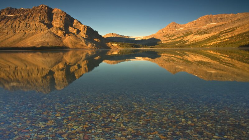 Mountain lake reflection at sunrise