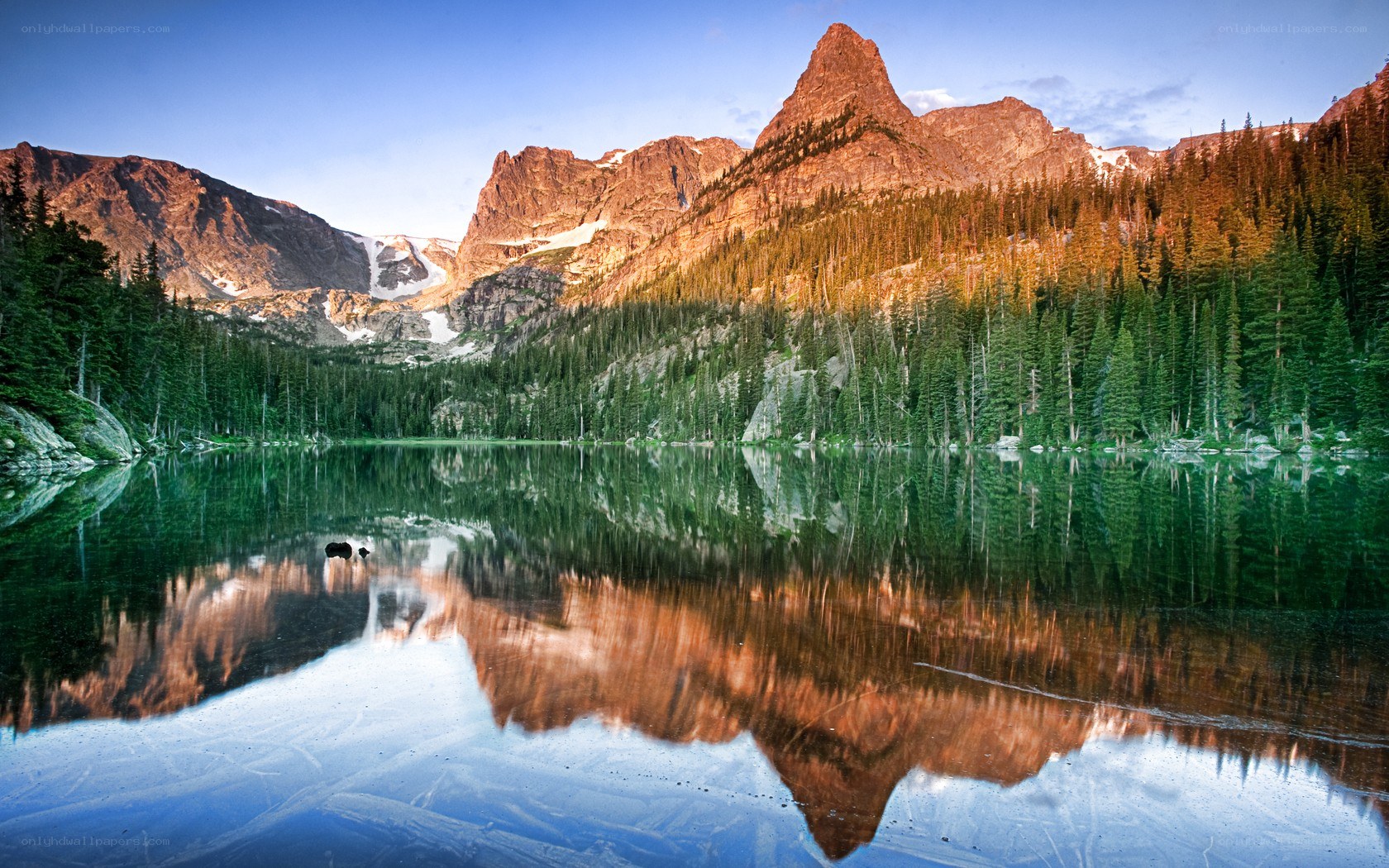 Mountain lake reflection at sunrise