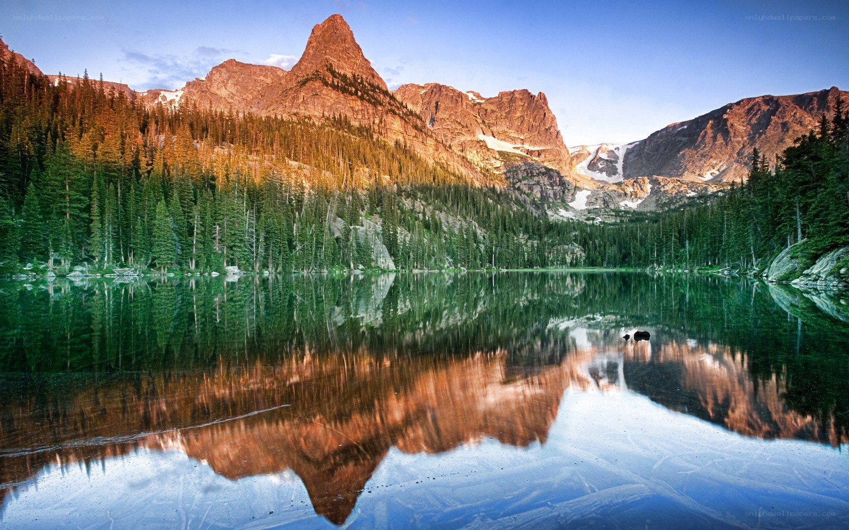 Mountain lake reflection at sunrise