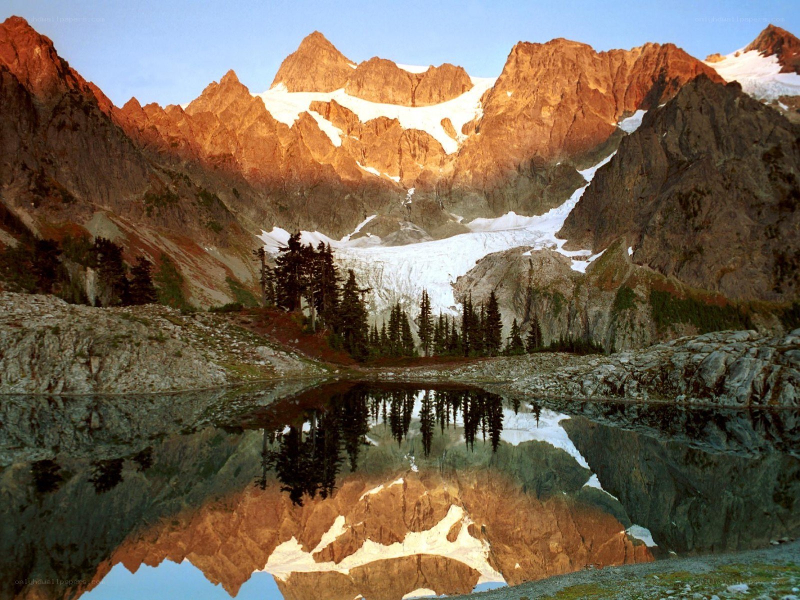Mountain lake reflection at sunrise