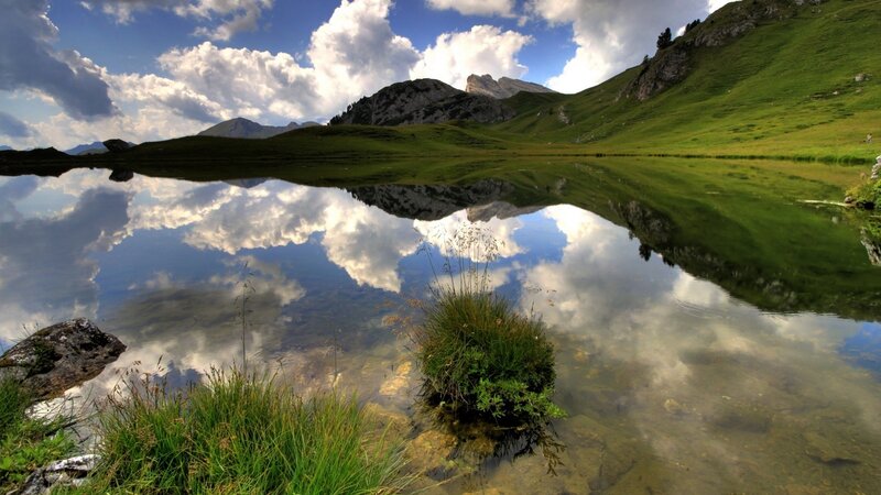 Mountain Lake Reflection — Blue, Serene, Afternoon, Photograph, Clouds, Grass, Rocks