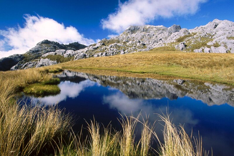 Mountain Lake Reflection — Blue, Serene, Afternoon, Photograph, Mountains, Grass, Sky, Clouds, Green, Gray