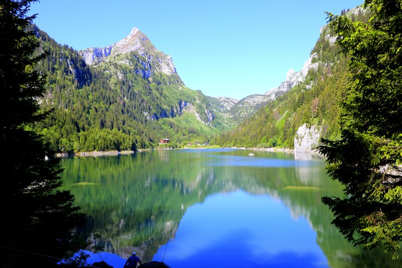 Mountain Lake Reflection — Blue, Serene, Afternoon, Photograph, Trees, Mountains, Boat