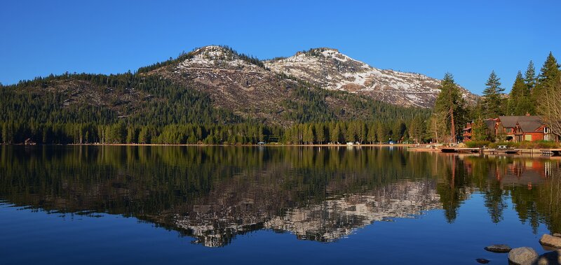 Mountain Lake Reflection — Blue, Serene, Afternoon, Photograph, Trees, Mountains, Buildings