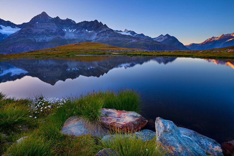 Mountain Lake Reflection — Blue, Serene, Sunset, Photograph, Mountains, Grass, Rocks