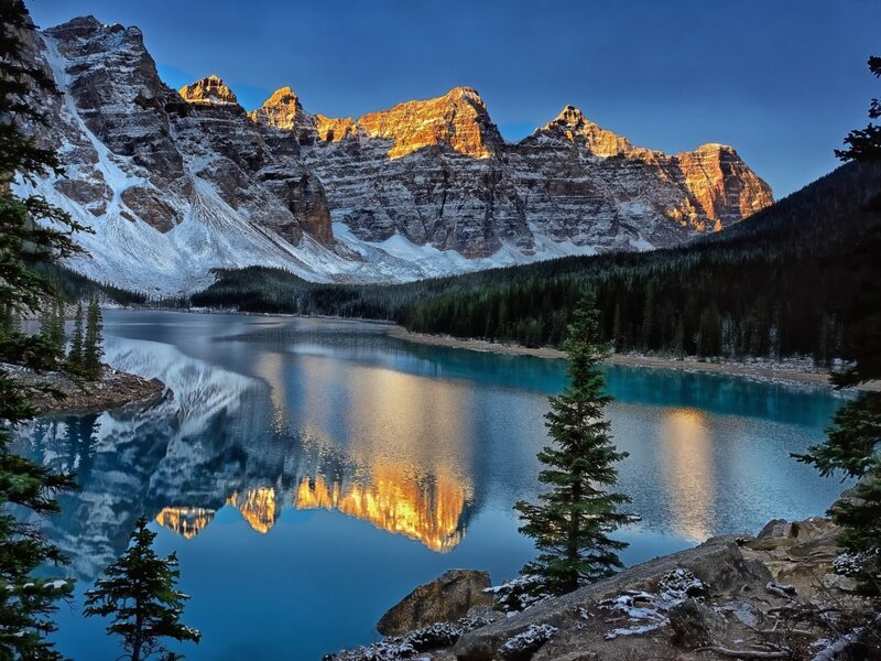 Mountain Lake Reflection — Blue, Serene, Sunset, Photograph, Snow-capped Mountains, Evergreen Trees