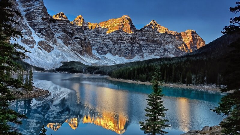 Mountain Lake Reflection — Blue, Serene, Sunset, Photograph, Snow-capped Mountains, Pine Trees