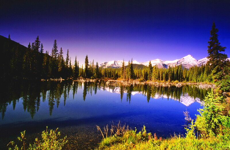 Mountain Lake Reflection — Blue, Serene, Sunset, Photograph, Trees, Snow-capped Mountains