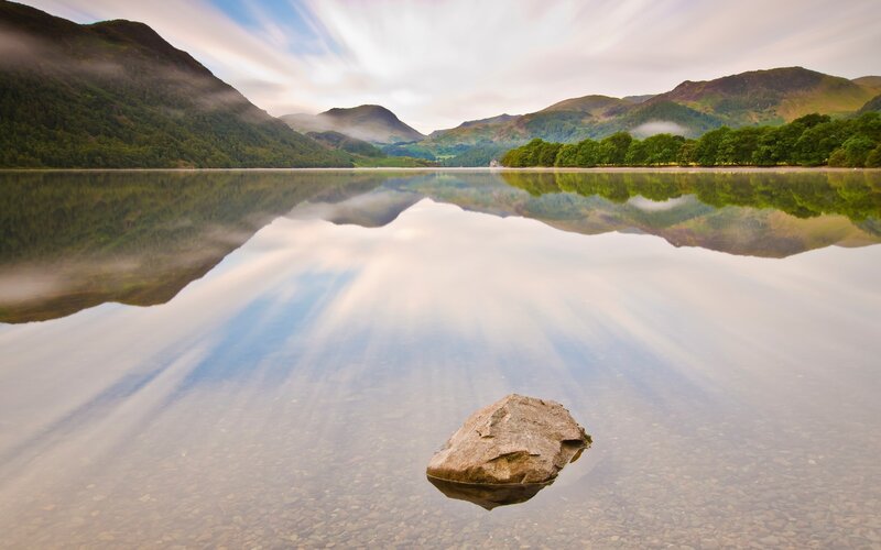 Mountain lake reflection with rock