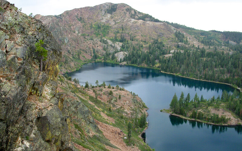 mountain lake surrounded by forest