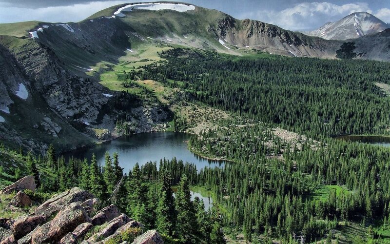 mountain lake surrounded by forest
