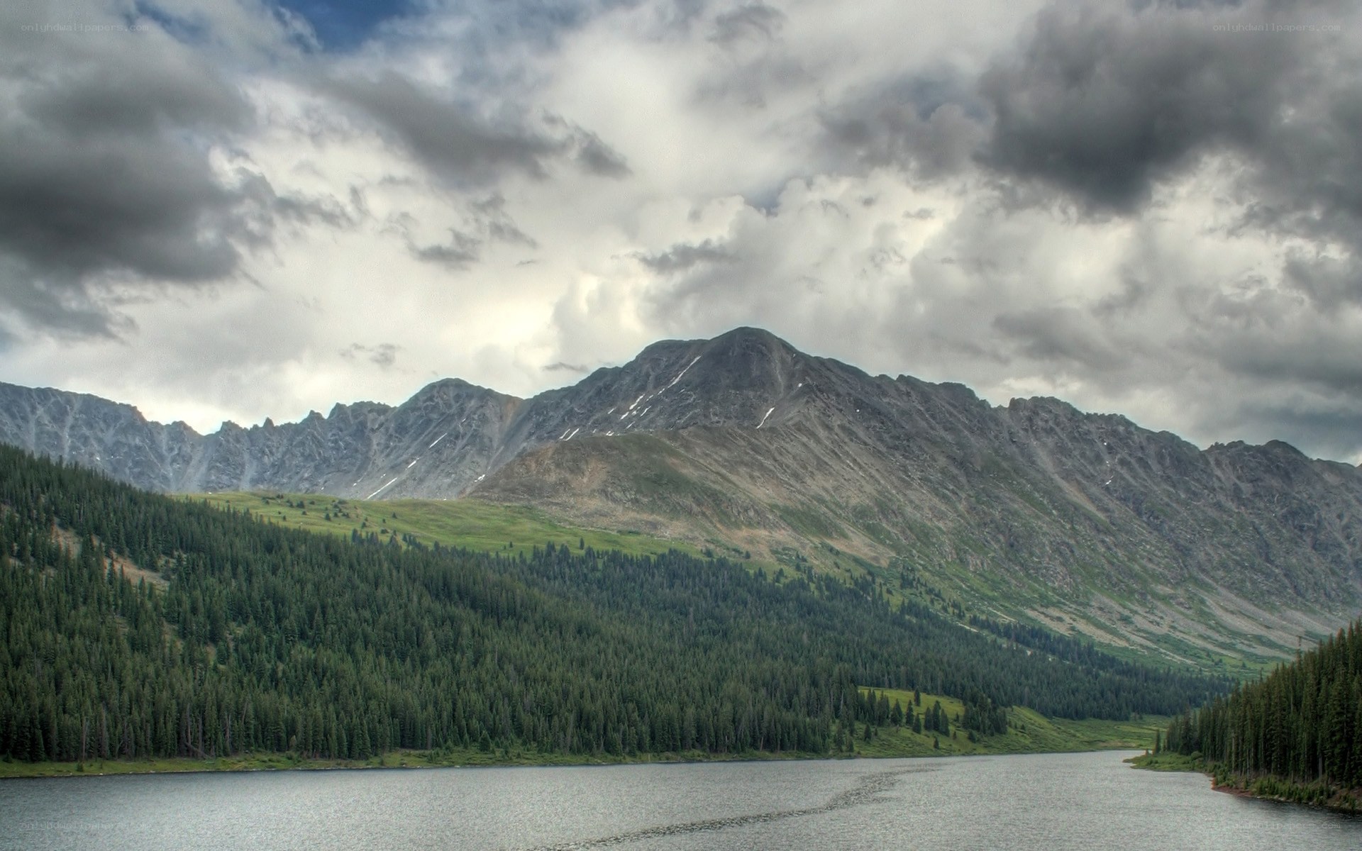 Mountain lake under cloudy sky
