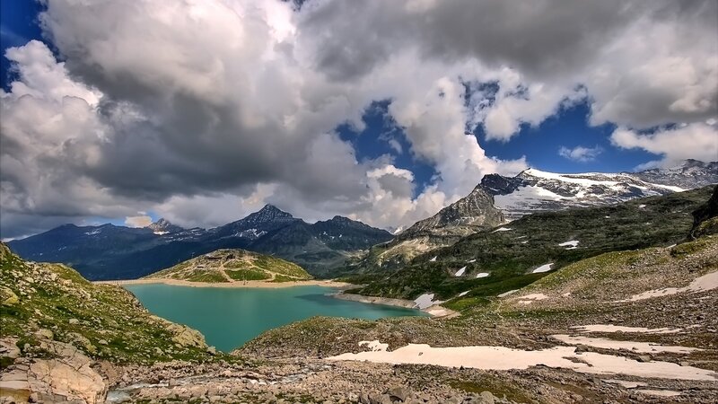 Mountain lake under cloudy sky